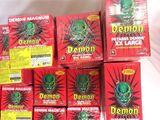 several boxes of demon wax sitting on top of a white table