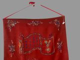 a red wall hanging with a sign on it
