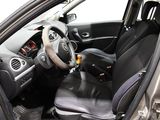the interior of a small car with a steering wheel and dashboard