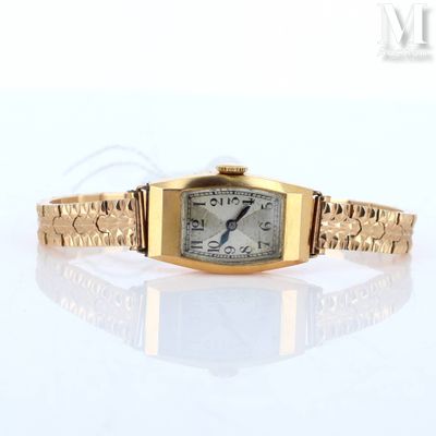 an image of a gold wrist watch on a white surface