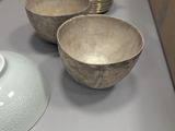three bowls and a bowl on a table with a box