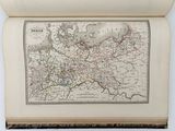 an old map of europe in a book on a table