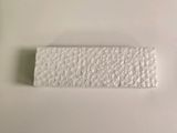 two pieces of white plastic on a table