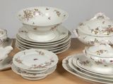 a table with a bunch of dishes and cups on it