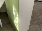 a white desk with a green counter top in an office