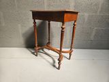 a small wooden table with a drawer on top of it