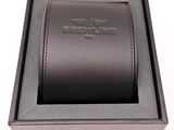 an image of a black watch in a black box on a white surface