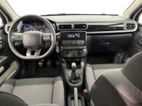 the interior of a small car with a steering wheel and dashboard