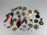 a lot of pins and brooches on a table