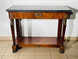 a small table with a marble top on wheels