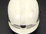 a white hard hat with a black band on it