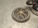a small metal object on a metal surface next to a tea kettle