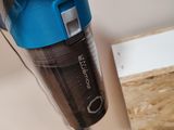 a person using a cordless vacuum cleaner to clean a piece of wood