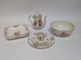 four pieces of china on a white table
