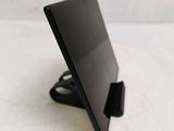 a black tablet on a stand on a white surface