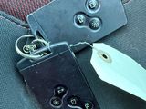 a keychain that is attached to the seat belt of a car