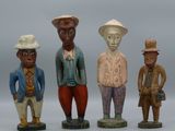 three figurines of men in different colors and hats standing next to each other