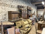 a lot of furniture in a room with a stone wall