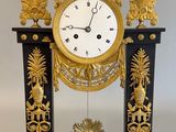 une horloge noire et or posée sur une table
