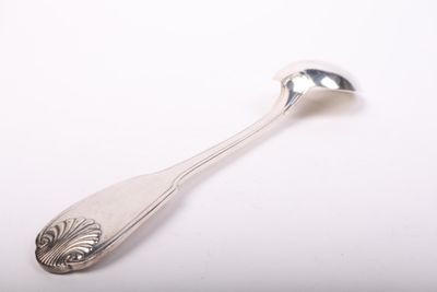 silver spoon on a white surface with a silver spoon in the middle of it