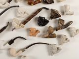 many different types of smoking pipes on the table
