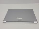an open laptop computer sitting on top of a white table