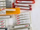 many different types of pens and pencils in this case