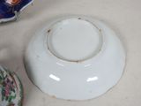 a white bowl and a blue and white bowl on a table