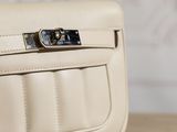 the back of a white purse sitting on top of a wooden table