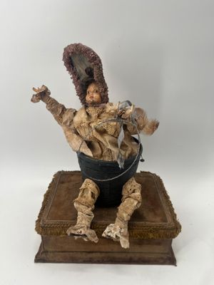 an image of a statue of a man sitting in a bucket
