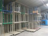 many shelves that are in a warehouse with a blue machine