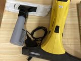 a yellow and black vacuum on a table next to other items
