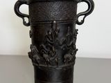 a black vase that is sitting on a table