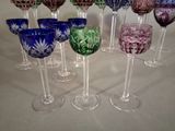 many wine glasses lined up in a row on a table