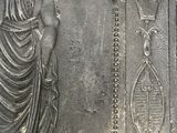 a statue of a man holding a dog on a plaque