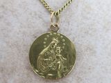 a close up of a gold coin on a gold chain