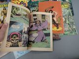 a person holding a comic book open on a table