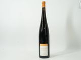 the bottle of wine is sitting on a white surface