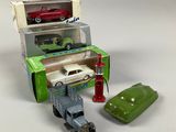 two toy cars and a toy car in a box