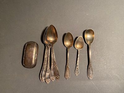 five spoons and a spoon rest on a table