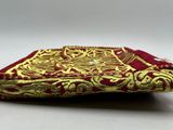 an image of a red and gold purse with a gold design