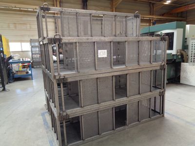a stack of crates in a warehouse with a machine in the background