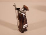 a figurine of a man holding a spoon and a cup