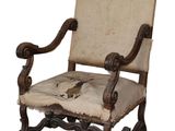 an old chair that has been upholstered with a bird on it
