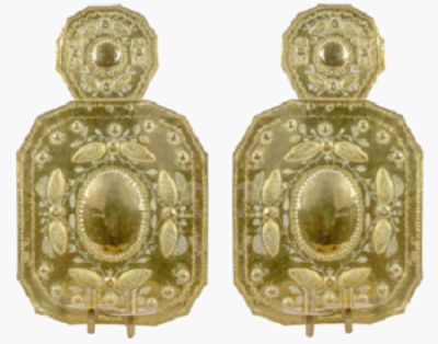 pair of antique brass door knobs with ornate design on each side