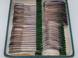 a lot of silverware in a case on the table
