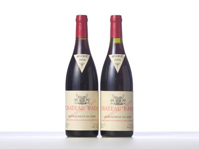 two bottles of red wine sitting next to each other on a table