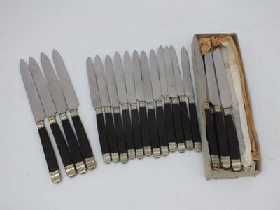 six knives in a wooden box with a box of matches