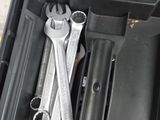 two wrenches in a tool box on the floor