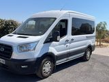 la camionnette blanche est garée sur le parking à côté des arbres